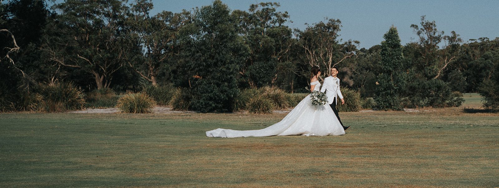 Newlyweds with the clubhouse golf cart